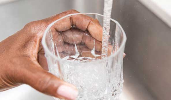 Hand filling up glass